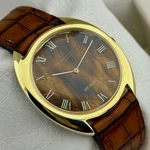 Universal Gen Gilt Shadow "tiger Eye" Dial Ref. 566101 Micro-rotor 1-66. Fixed Price $2600.00.
